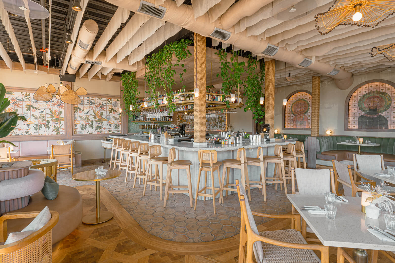 Coastal bar and dining room with woven pendants and natural textures