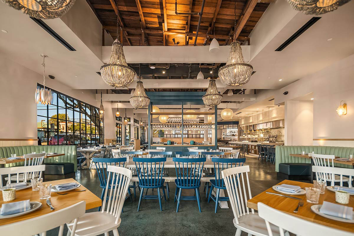 Beaded coastal chandeliers in a bright dining room