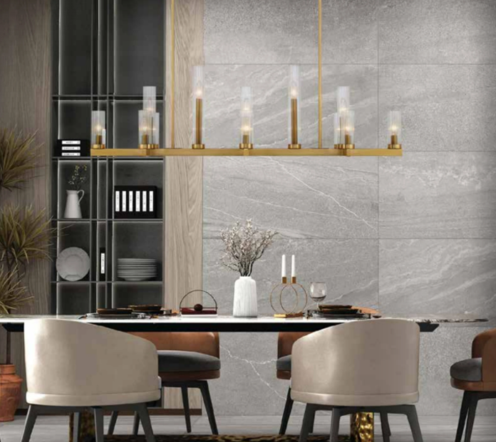 Linear chandelier-style fixture over a dining nook adjacent to an open kitchen