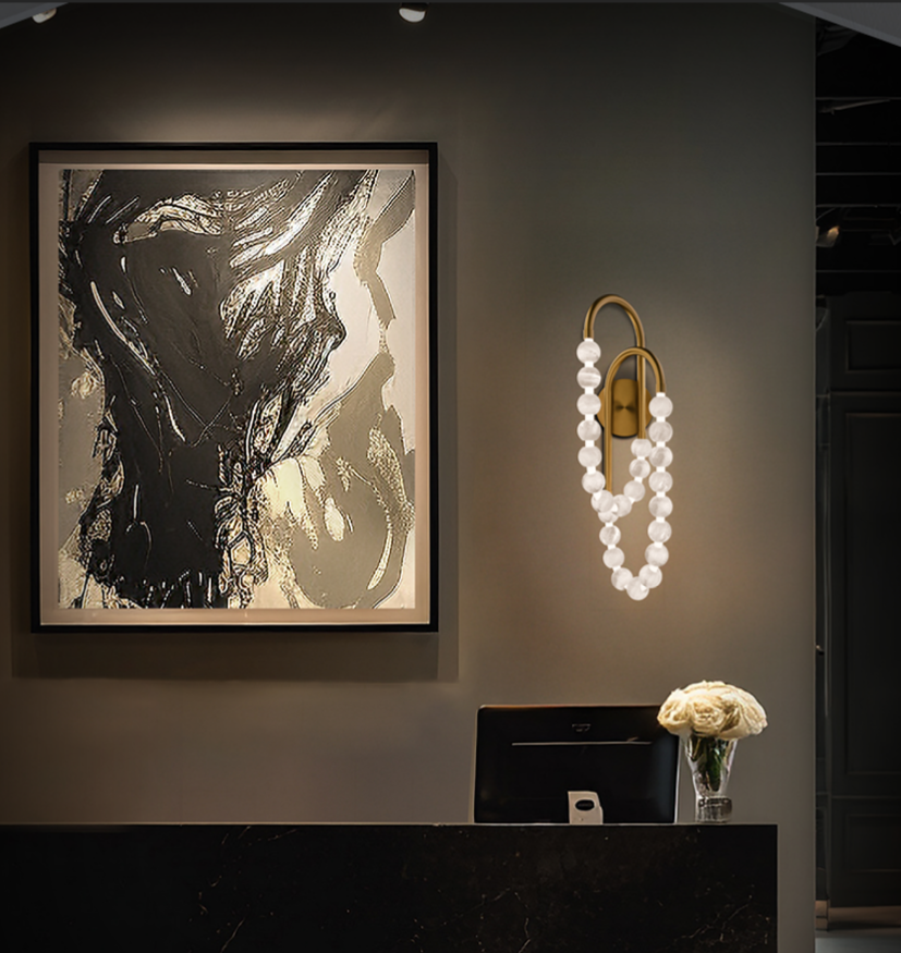 Sculptural brass wall sconce with pearl-style bulbs as a dominant finish accent