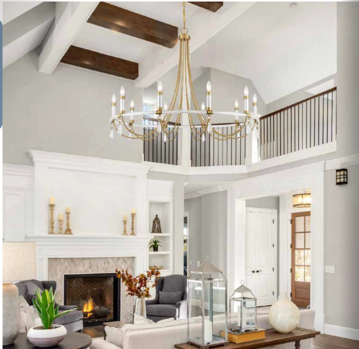 Vaulted living room with gold chandelier, fireplace, and coordinated accent lighting
